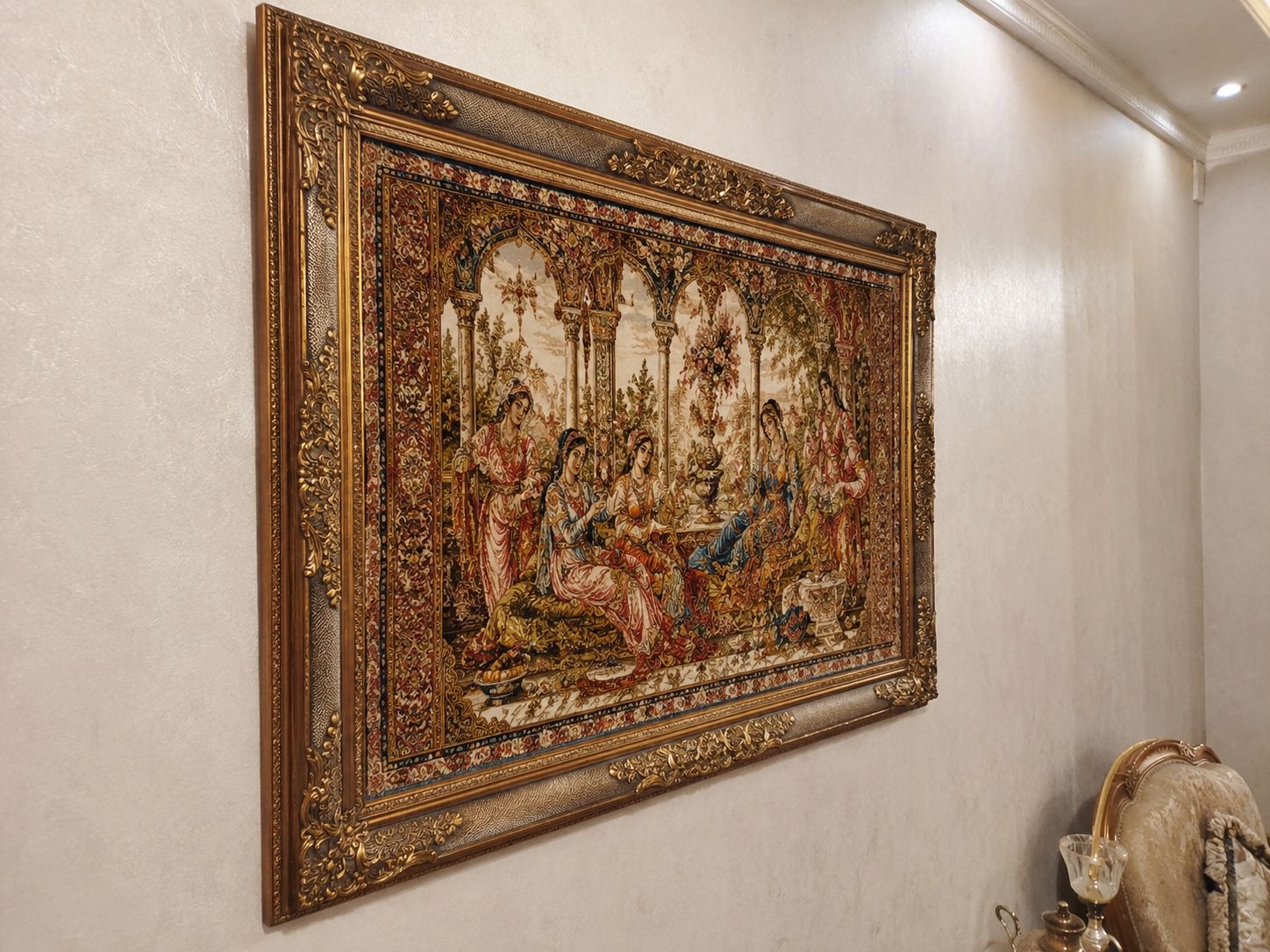 Framed Persian wall rug depicting a palace garden scene